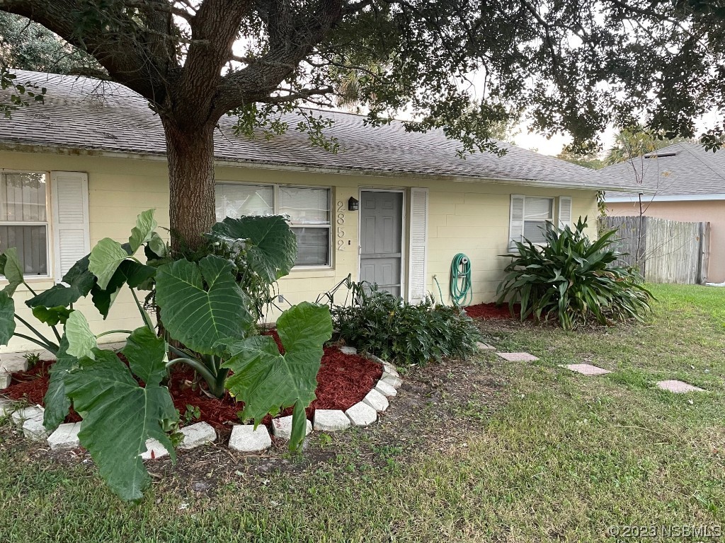 2352 Fern Palm Drive Edgewater, FL 32141 - Photo 2 of 12 a front view of a house with a yard
