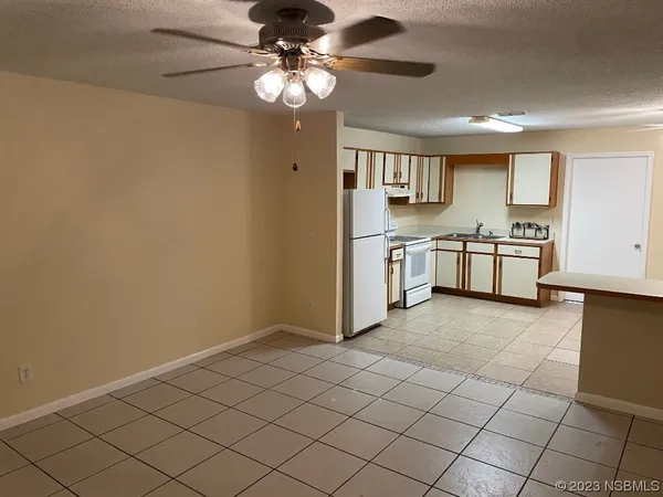 a large kitchen with cabinets and stainless steel appliances