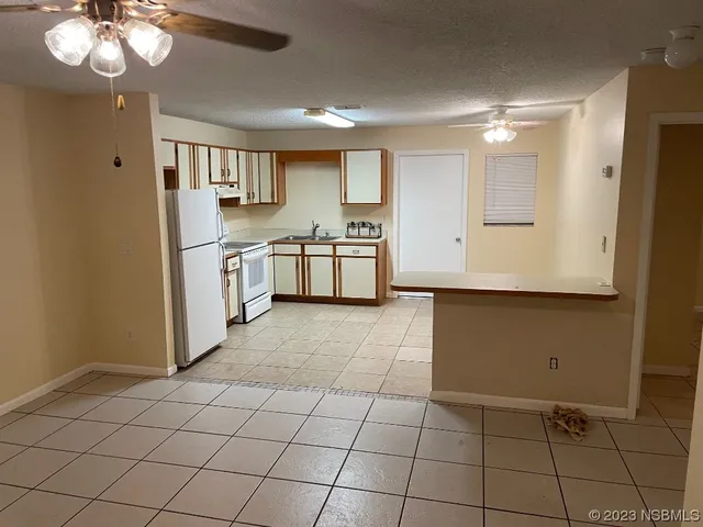 a kitchen with stainless steel appliances a refrigerator and a stove top oven