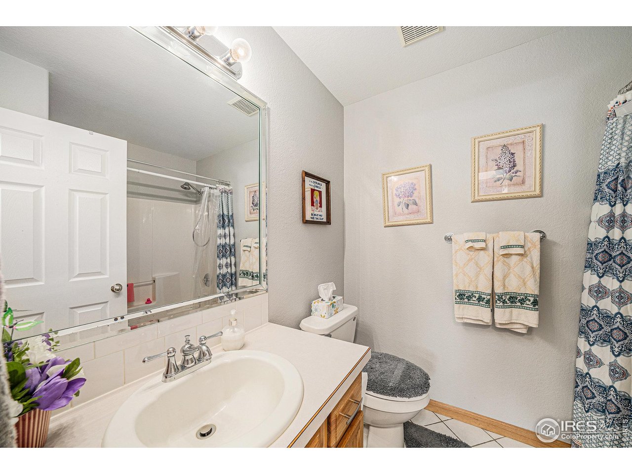 3182 50th Avenue Greeley, CO 80634 - Photo 12 of 21 a bathroom with a sink and a mirror with toilet