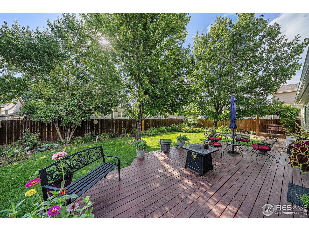 3182 50th Avenue Greeley, CO 80634 - Photo 16 of 21 a view of a wooden deck with furniture and garden