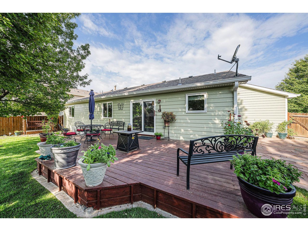 3182 50th Avenue Greeley, CO 80634 - Photo 18 of 21 a view of house with backyard and outdoor seating