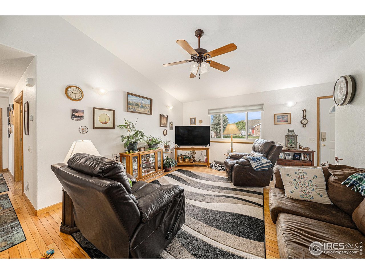3182 50th Avenue Greeley, CO 80634 - Photo 6 of 21 a living room with furniture a flat screen tv and a window