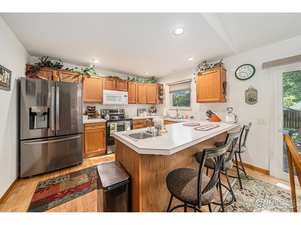 3182 50th Avenue Greeley, CO 80634 - Photo 8 of 21 a kitchen with stainless steel appliances a sink a table and chairs