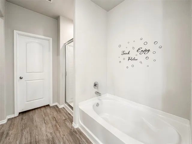 a spacious bedroom with a bed and a window