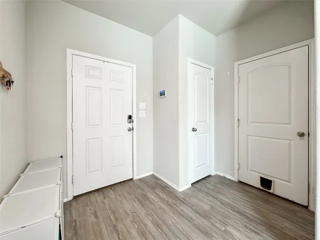 a bedroom with a bed a mirror on dresser and a window