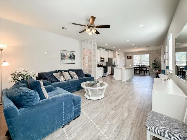 a living room with furniture and kitchen view