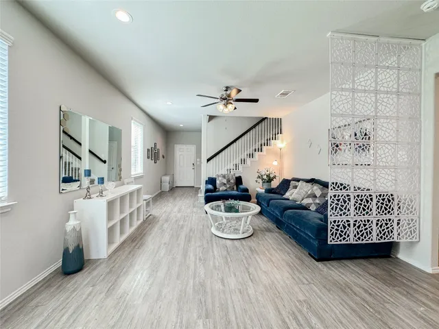 a living room with furniture and wooden floor