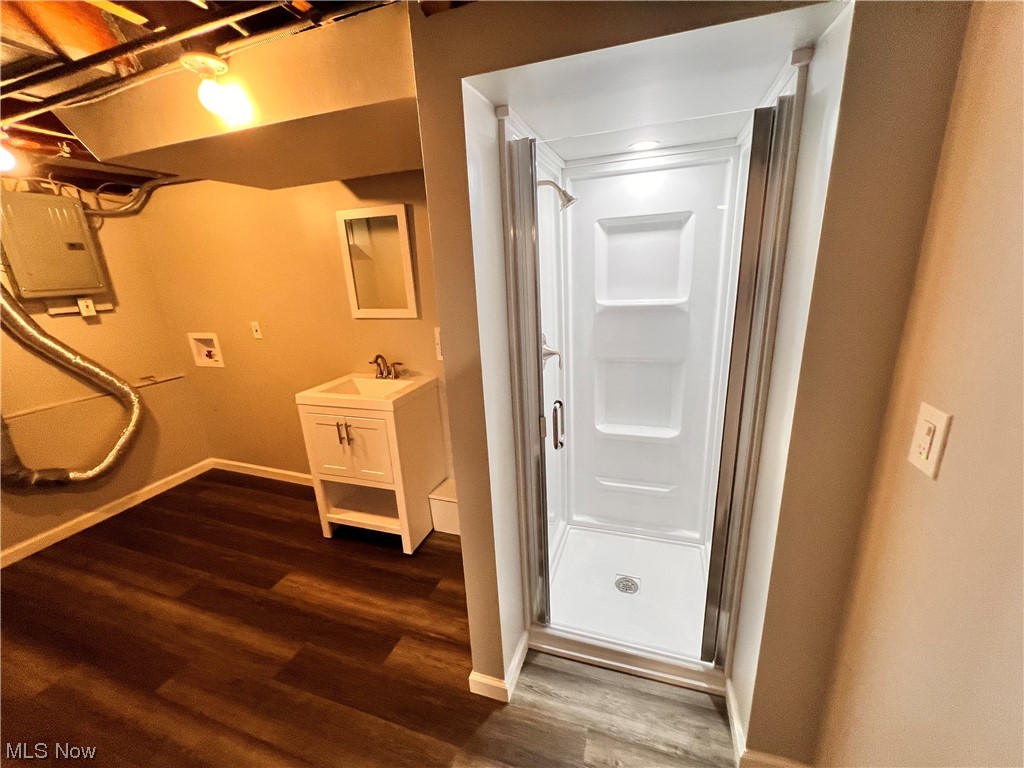 1376 Lander Road Cleveland, OH 44124 - Photo 28 of 33 basement Bathroom with walk in shower, hardwood flooring, and vanity