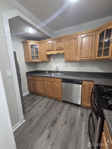 a kitchen with wooden floors and a sink