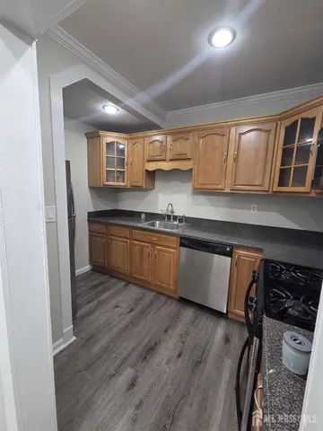 a kitchen with granite countertop a stove and a sink
