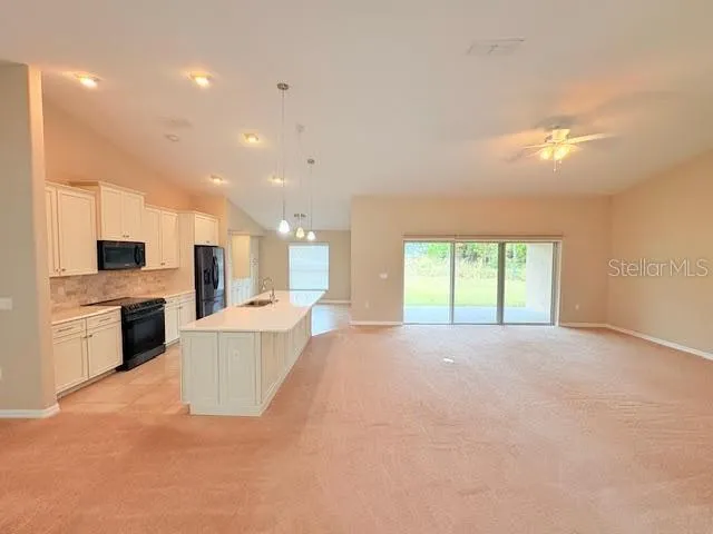 a view of a kitchen with furniture and a window