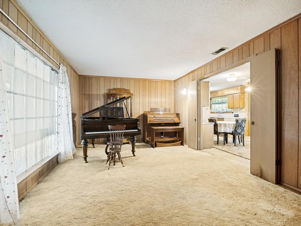 1081 Wright Street Terrell, TX 75160 - Photo 9 of 29 Interior room featuring light-colored carpeting and wood paneling