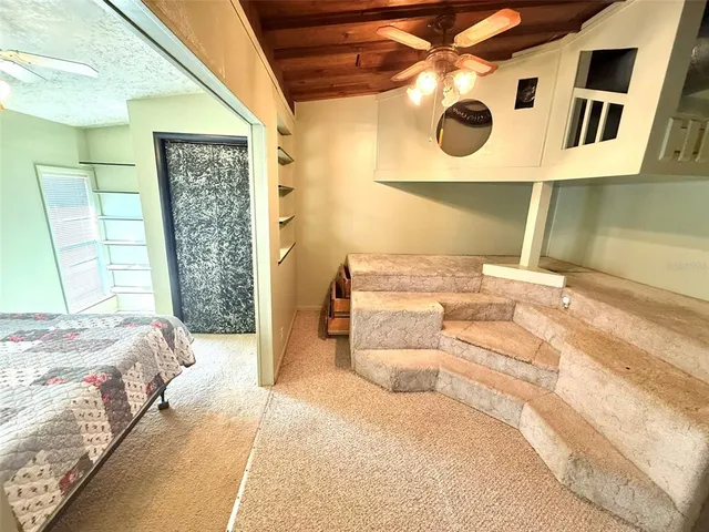 a living room with granite countertop toilet and sink