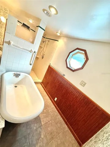 an empty room with a ceiling fan and a window