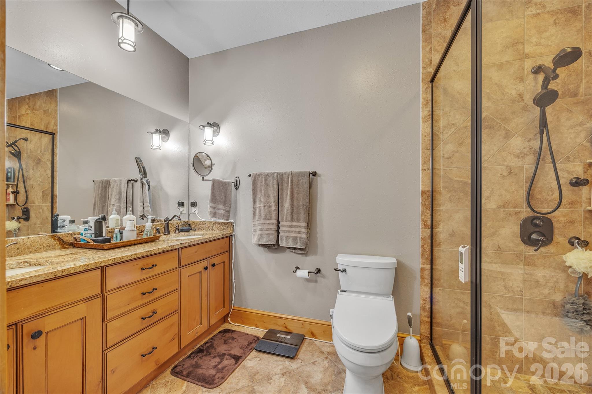 89 Springhouse Drive, Unit A4 Elk Park, NC 28622 - Photo 15 of 40 a spacious bathroom with a granite countertop sink toilet and shower