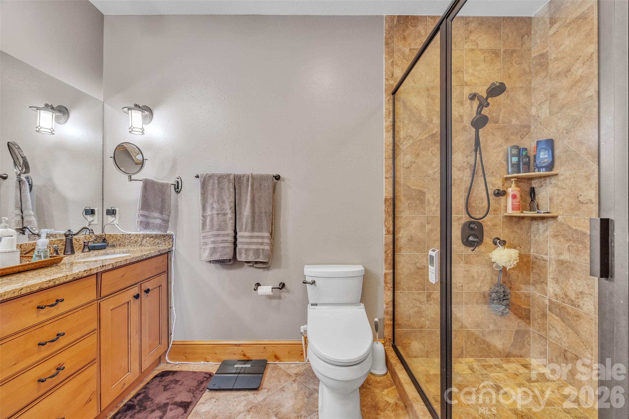 89 Springhouse Drive, Unit A4 Elk Park, NC 28622 - Photo 16 of 40 a bathroom with a granite countertop sink toilet and shower