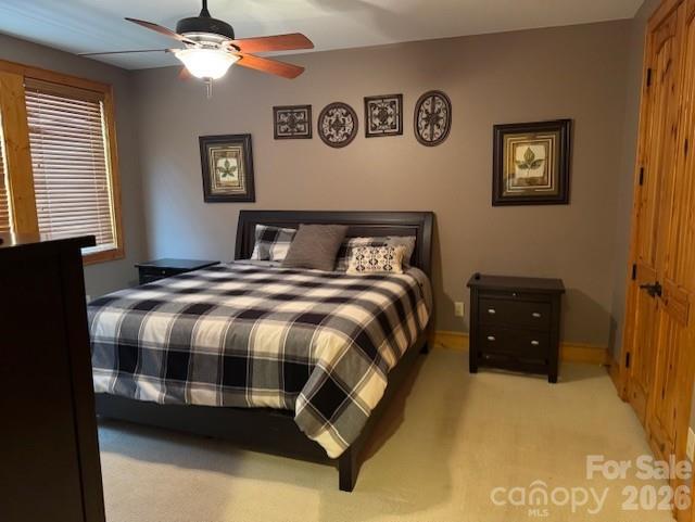 89 Springhouse Drive, Unit A4 Elk Park, NC 28622 - Photo 17 of 40 a bedroom with a bed and a chandelier