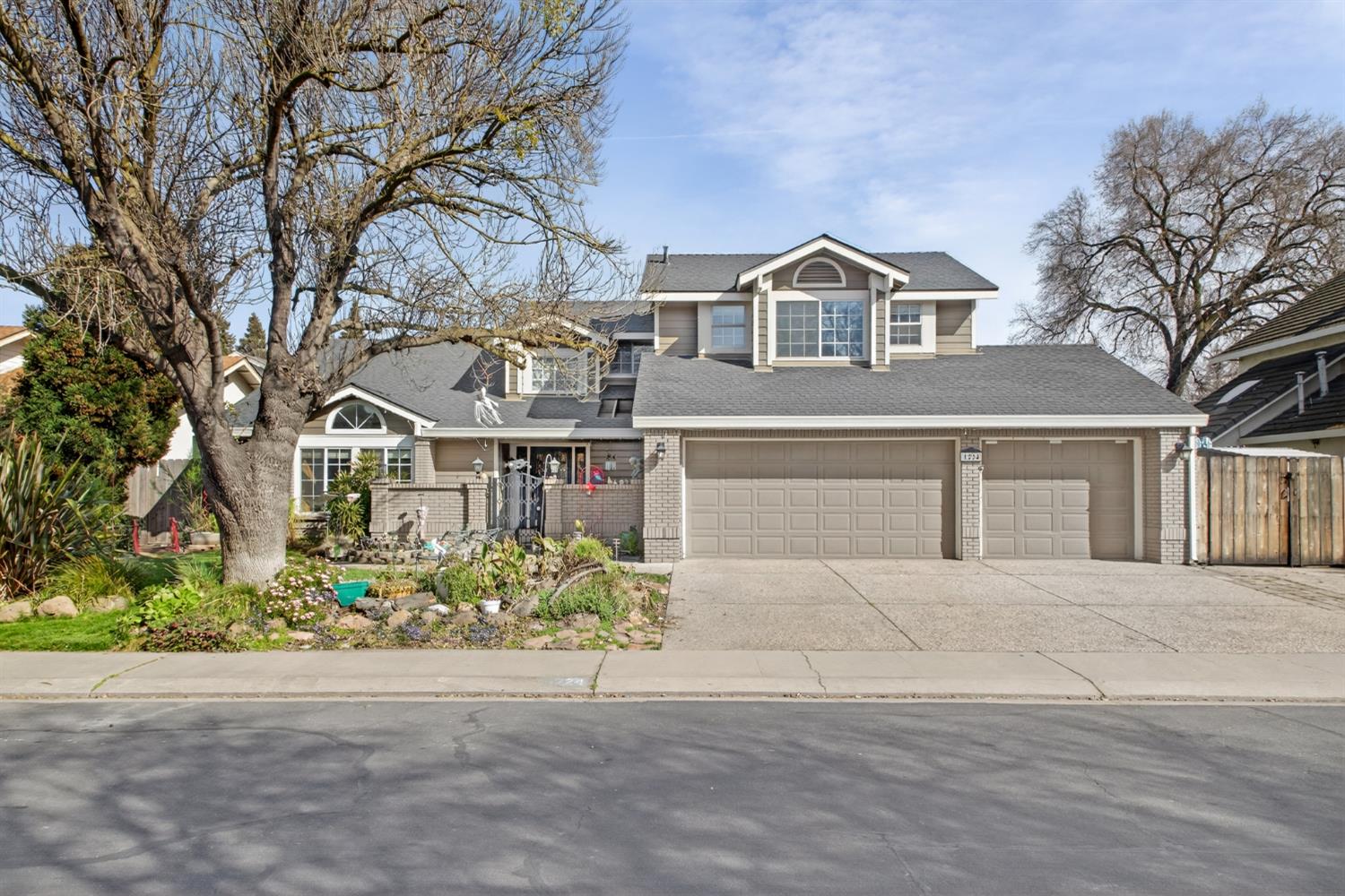 1224 Glenbrook Way Modesto, CA 95355 - Photo 2 of 49 a view of a white house with a yard and potted plants