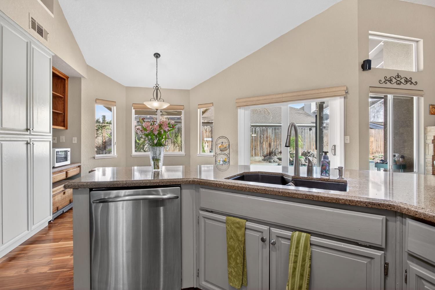 1224 Glenbrook Way Modesto, CA 95355 - Photo 21 of 49 a kitchen with granite countertop a sink and a refrigerator