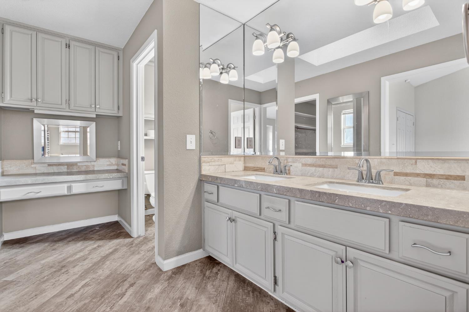 1224 Glenbrook Way Modesto, CA 95355 - Photo 34 of 49 a spacious bathroom with a granite countertop sink mirror and cabinets
