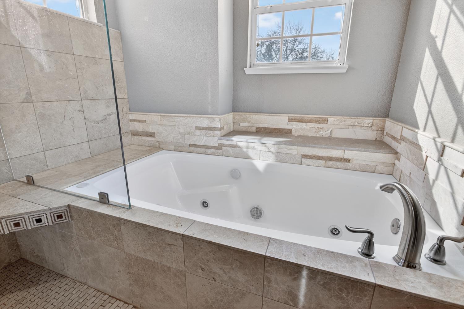 1224 Glenbrook Way Modesto, CA 95355 - Photo 35 of 49 a bathroom with a tub sink and mirror