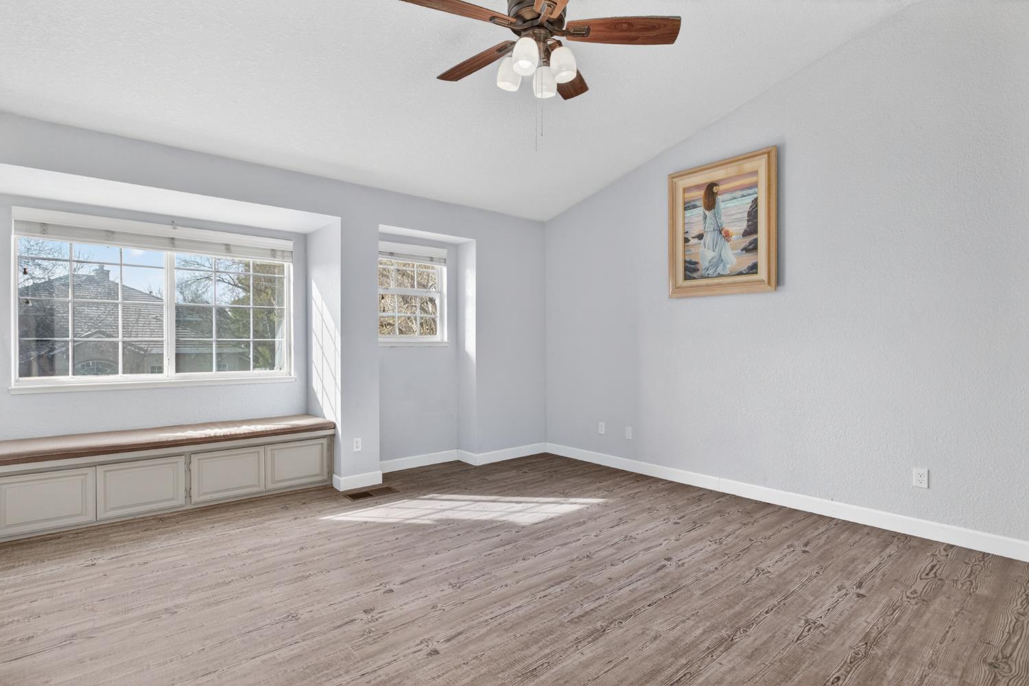 1224 Glenbrook Way Modesto, CA 95355 - Photo 39 of 49 a view of an empty room with a window and wooden floor