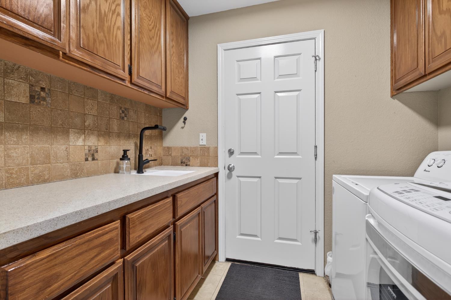 1224 Glenbrook Way Modesto, CA 95355 - Photo 40 of 49 a kitchen with a sink and cabinets