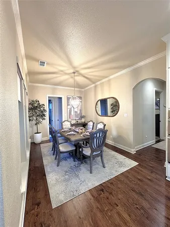 a view of a dining room with furniture and wooden floor