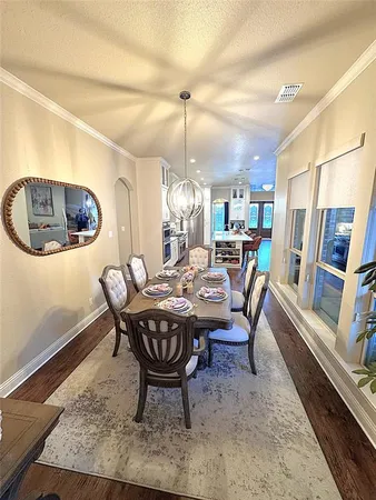 a dining room with furniture a rug and wooden floor