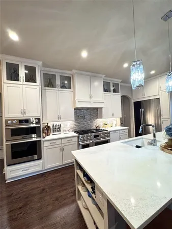 a kitchen with a stove a sink and a refrigerator