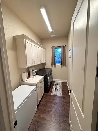 a kitchen with a sink and wooden floor