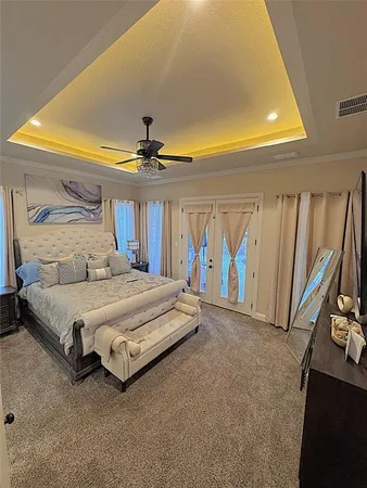 a spacious bedroom with a bed and a painting on the wall