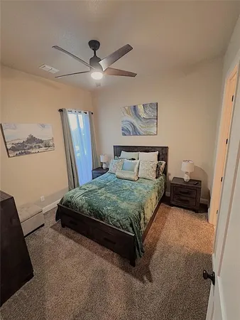 a bedroom with a bed and a mirror