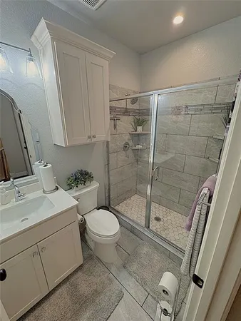 a bathroom with a sink toilet and shower