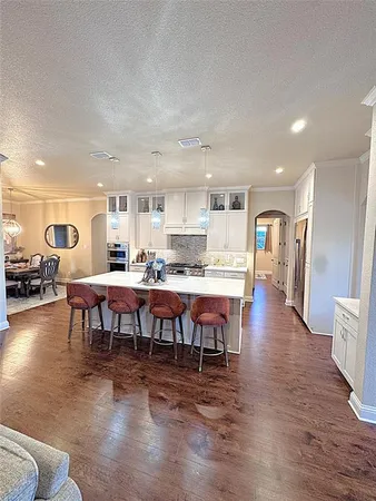 a large kitchen with a table and chairs