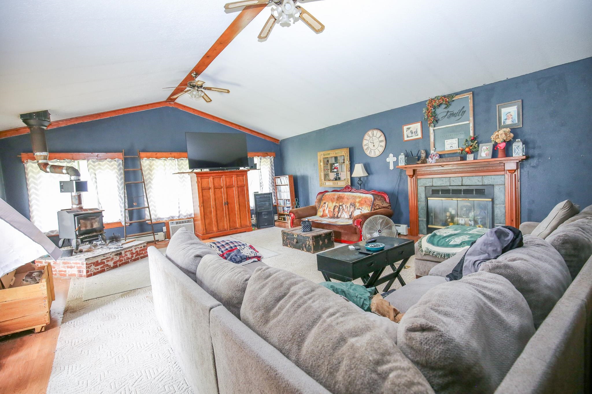 2144 Swarts Road Dixon, IL 61021 - Photo 5 of 31 a living room with furniture a fireplace and a large mirror