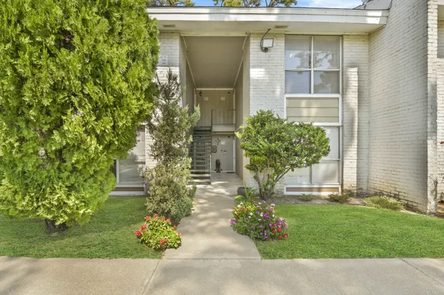 a front view of a house with garden