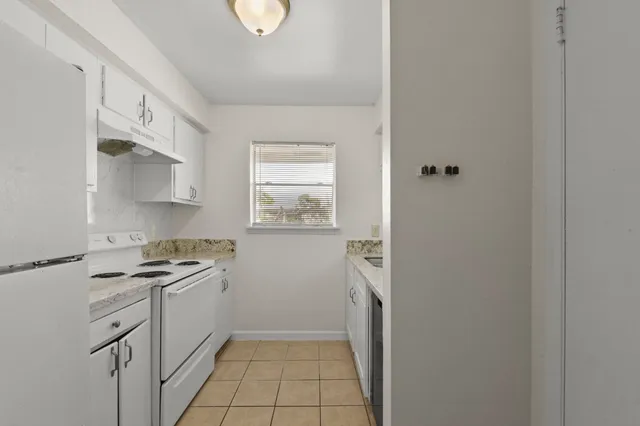 a kitchen with a stove a sink and a refrigerator