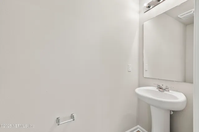 a bathroom with a sink and mirror