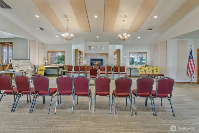 a living room with furniture and a book shelf