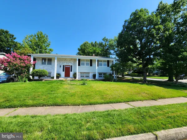 a view of house with backyard and garden