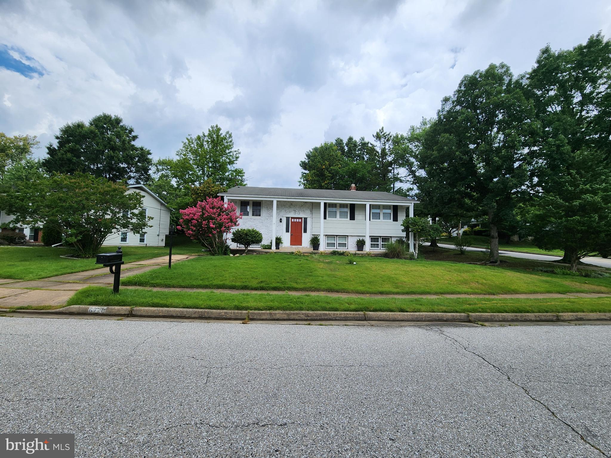 6720 Garvey Road Baltimore, MD 21237 - Photo 2 of 13 a front view of house with yard and green space