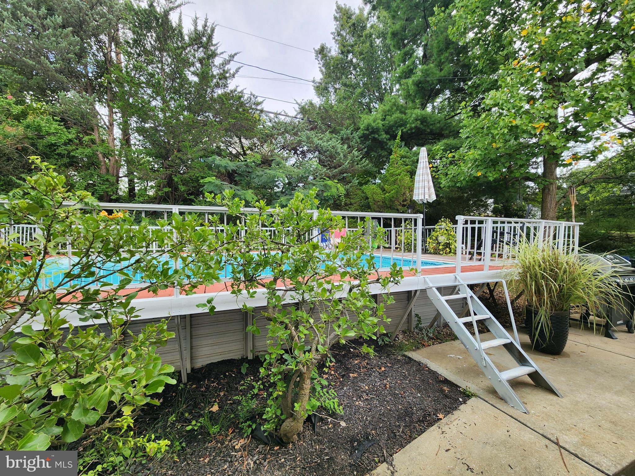 6720 Garvey Road Baltimore, MD 21237 - Photo 10 of 13 a view of a deck with a table and chairs potted plants