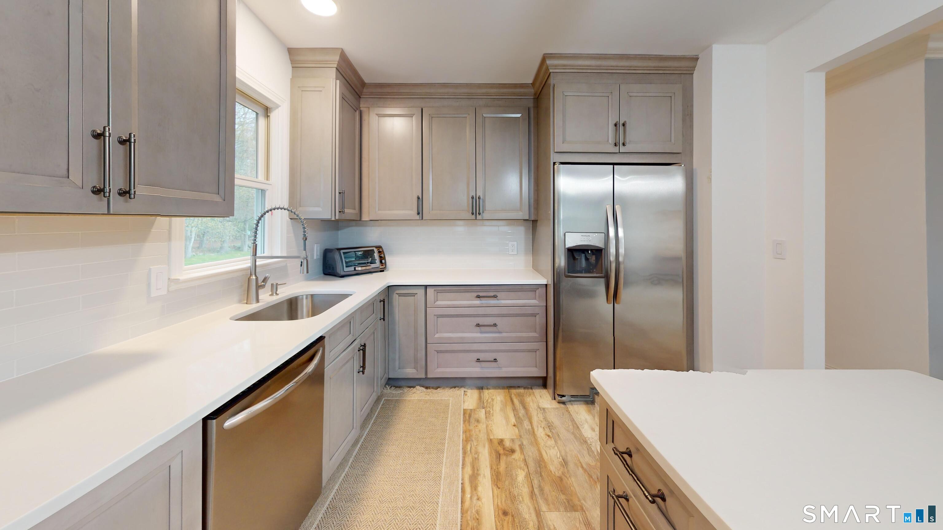 29 Deer Ridge Road Stonington, CT 06378 - Photo 21 of 35 a kitchen with cabinets stainless steel appliances and a counter space