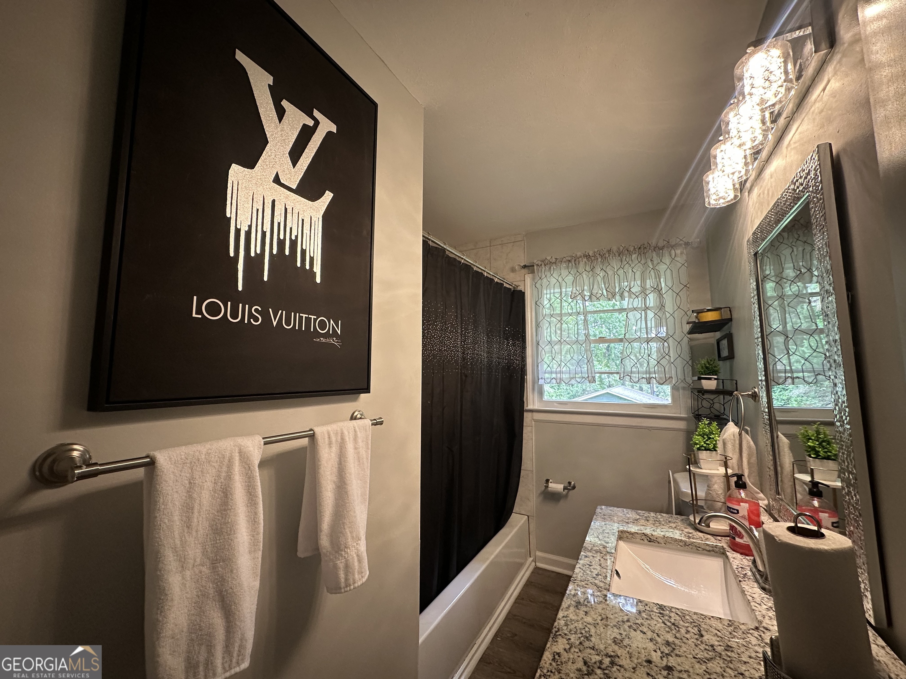 7383 Pleasant Hill Road Lithonia, GA 30058 - Photo 14 of 18 a view of walk in closet with clothes and shoes