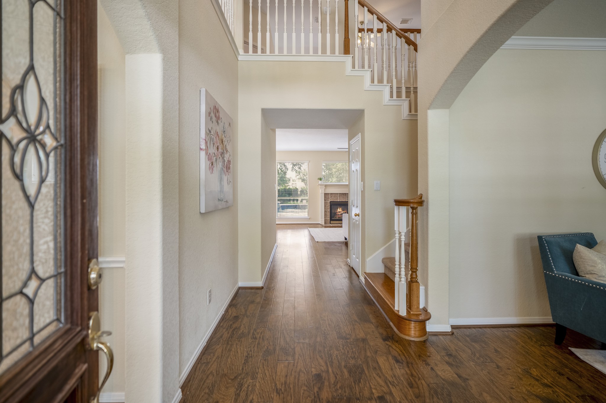 5807 Sequoia Trace Court Spring, TX 77379 - Photo 4 of 50 Stepping inside, the foyer is framed by the formal dining room on one side and formal living room on the other, with warm laminate flooring, a sweeping staircase, and a clear path toward the family room at the back of the home.