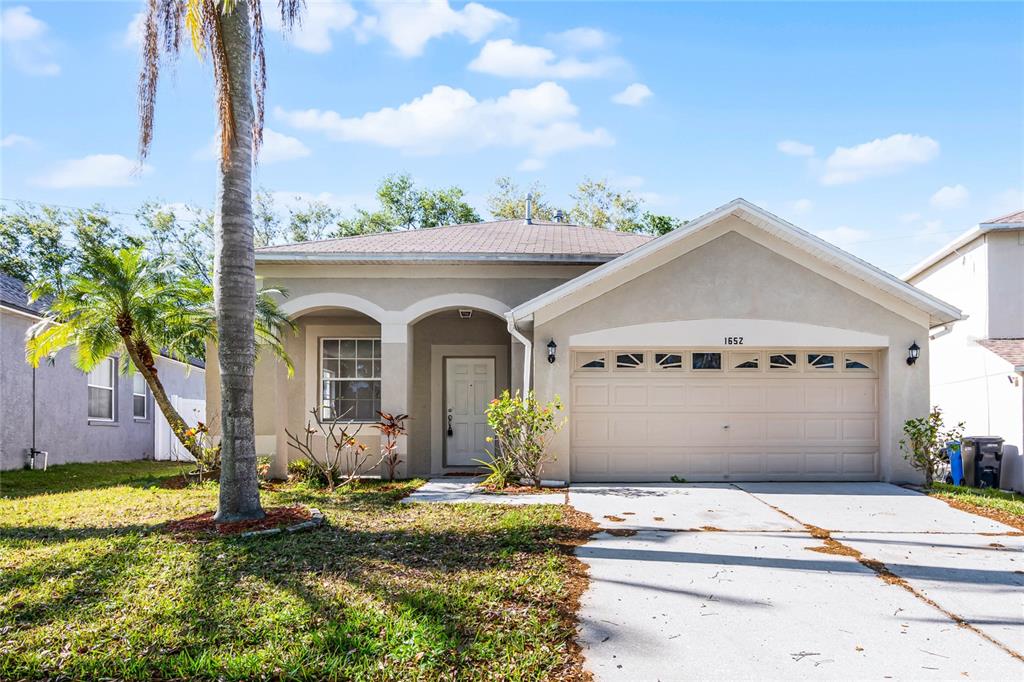 1652 Open Field Loop Brandon, FL 33510 - Photo 1 of 1 a front view of a house with garden