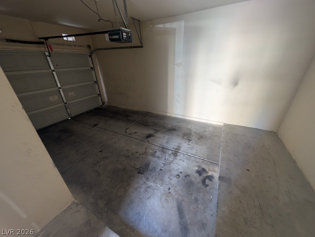 10550 West Alexander Road, Unit 2117 Las Vegas, NV 89129 - Photo 24 of 24 Concrete flooring and an automatic overhead door define this functional garage space.