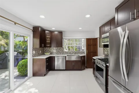 a kitchen with stainless steel appliances granite countertop a refrigerator and a sink
